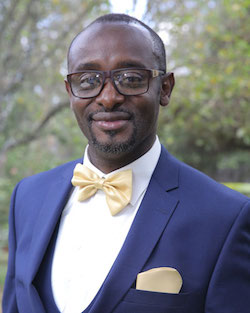 A person wears glasses and a bowtie.